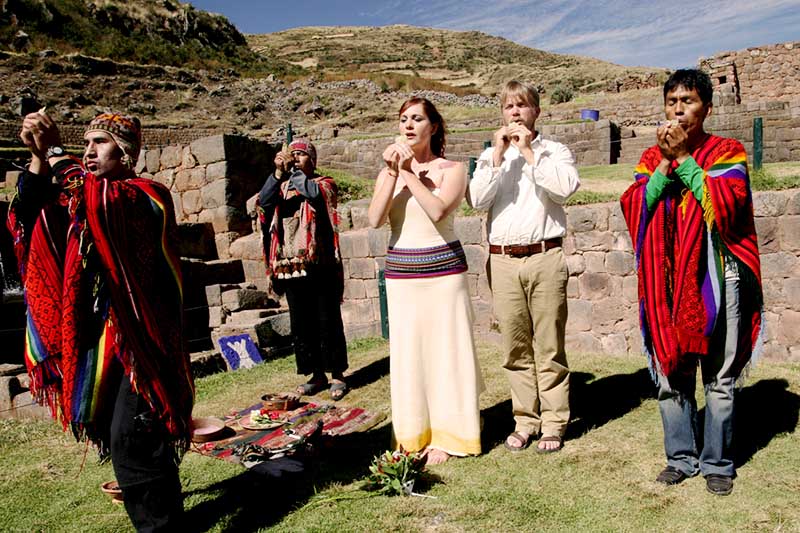 Payment to the Earth in the Andes Couple of tourists making a payment to the land