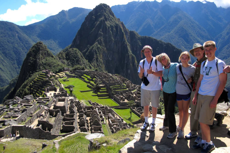 A family of tourists enjoying their visit to Machu Picchu