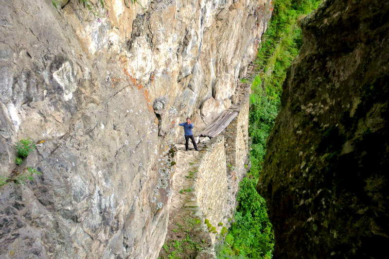 Tourist on the Inca Bridge of Machu Picchu