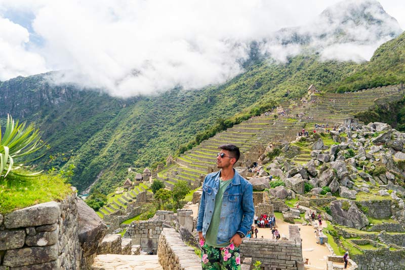 Tourist exploring the ruins of Machu Picchu